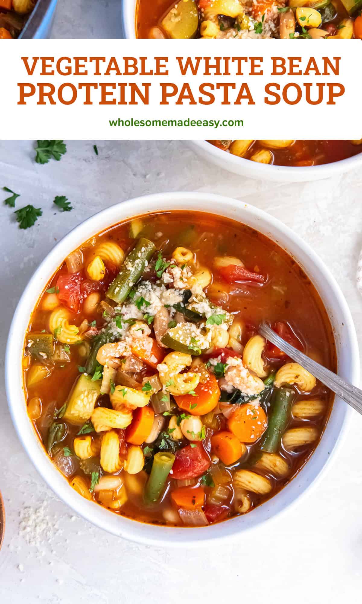 Two bowls of vegetable white bean protein pasta soup topped with Parmesan and fresh parsley, with colorful vegetables and curly protein pasta in a rich tomato broth with text overlay.