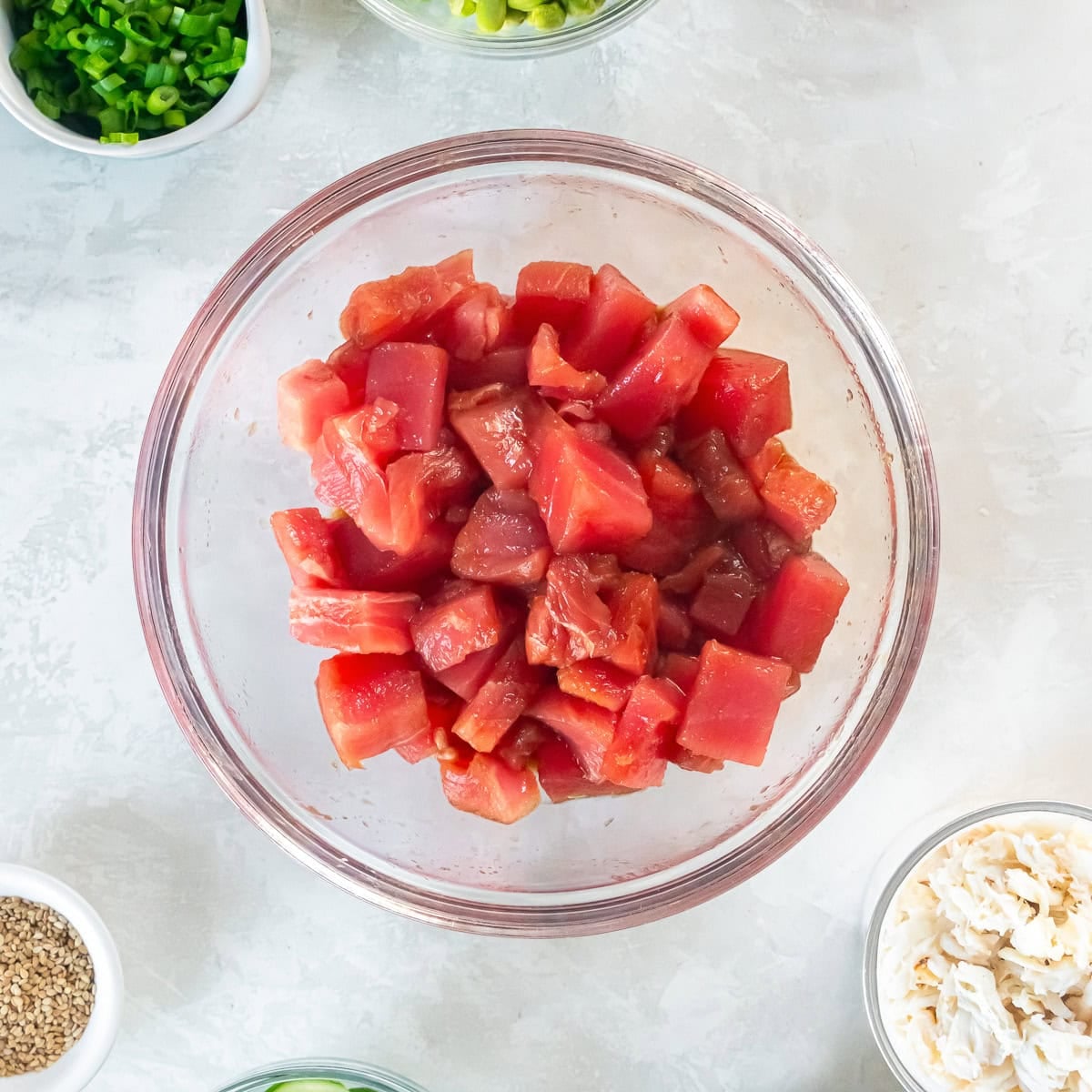 Cubed ahi tuna marinating in soy sauce, mirin, and sesame oil for poke bowls.