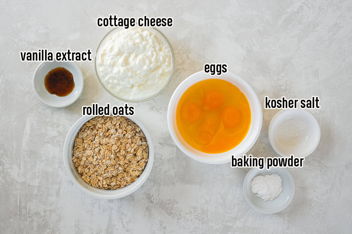 Cottage cheese pancakes ingredients including rolled oats, eggs, cottage cheese, vanilla extract, baking powder, and kosher salt.