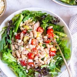 Tuna and White Bean Salad served over mixed greens with cannellini beans, albacore tuna, cherry tomatoes, celery, red onion, capers, feta cheese, and red wine vinaigrette.