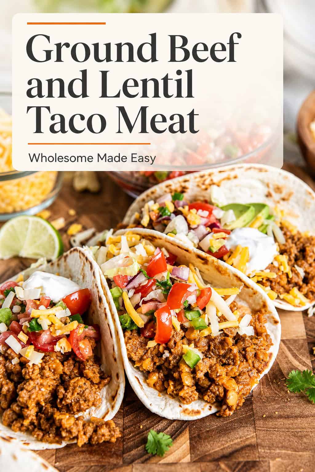 Tacos filled with ground beef taco meat and red lentils, topped with cheese, pico de gallo, avocado, lettuce, and sour cream with title text overlay.