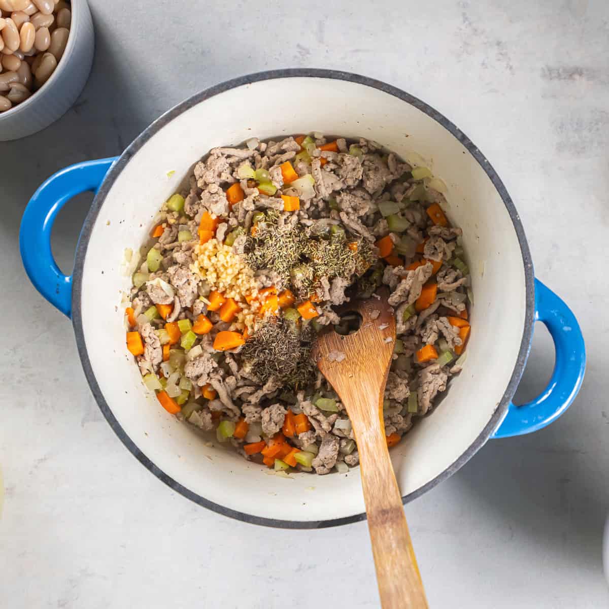 Cooked ground turkey with diced onion, carrots, and celery, with garlic, rosemary, and thyme added.